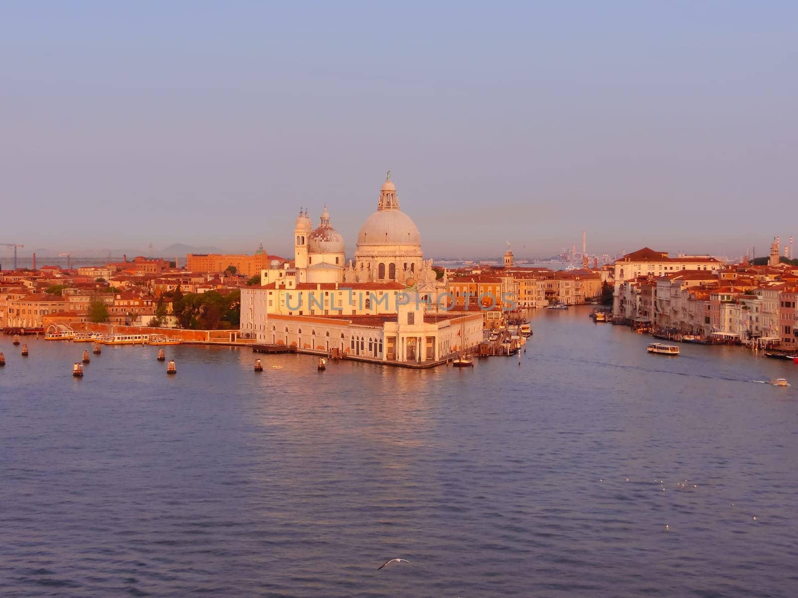 Beautiful view from Grand Canal on colorful facades of old medieval houses in Venice, Italy at sunset