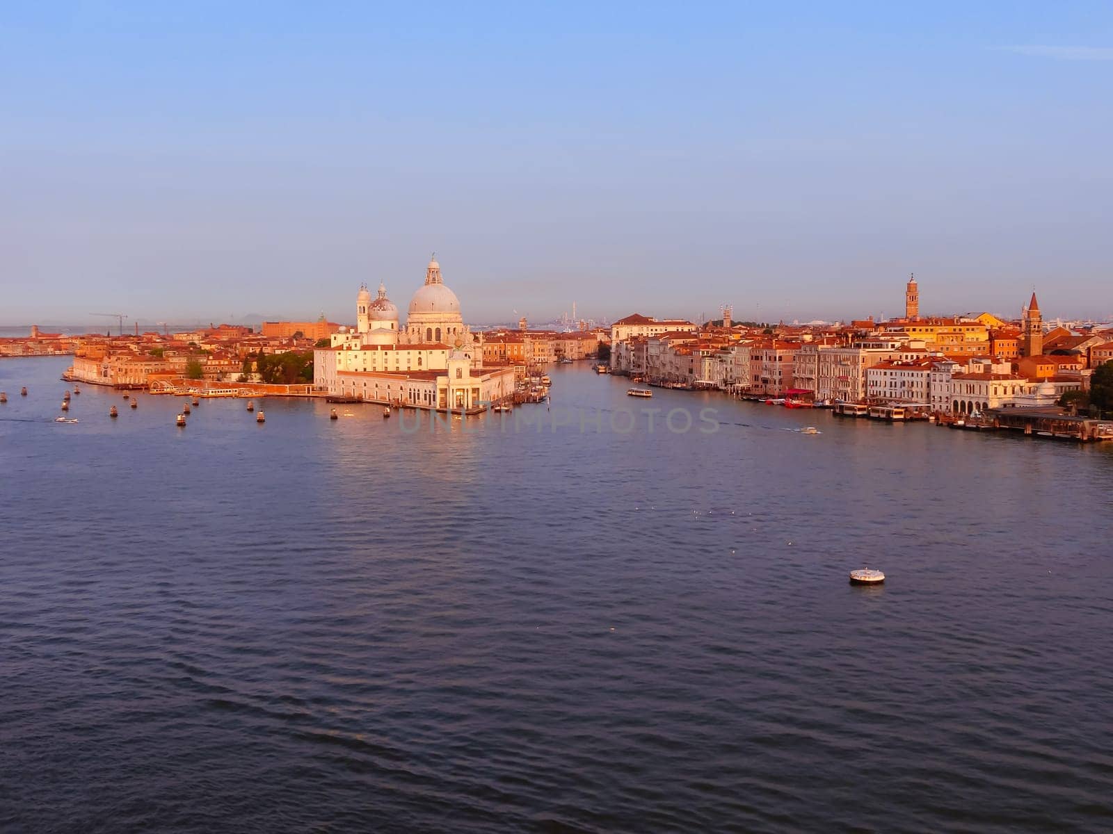 Beautiful view from Grand Canal on colorful facades of old medieval houses in Venice, Italy at sunset