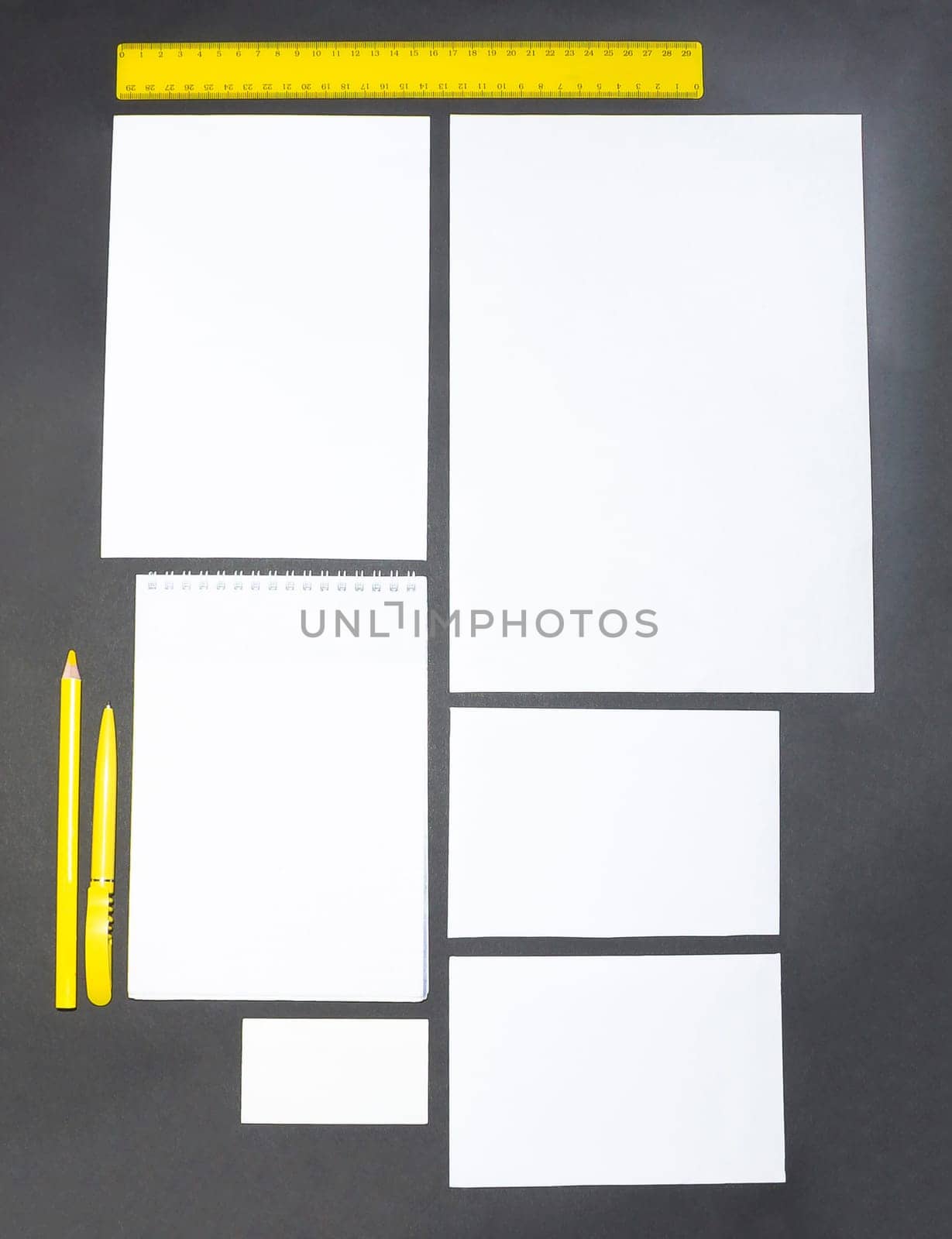 Mock-up business template with cards, papers, pen on gray background.