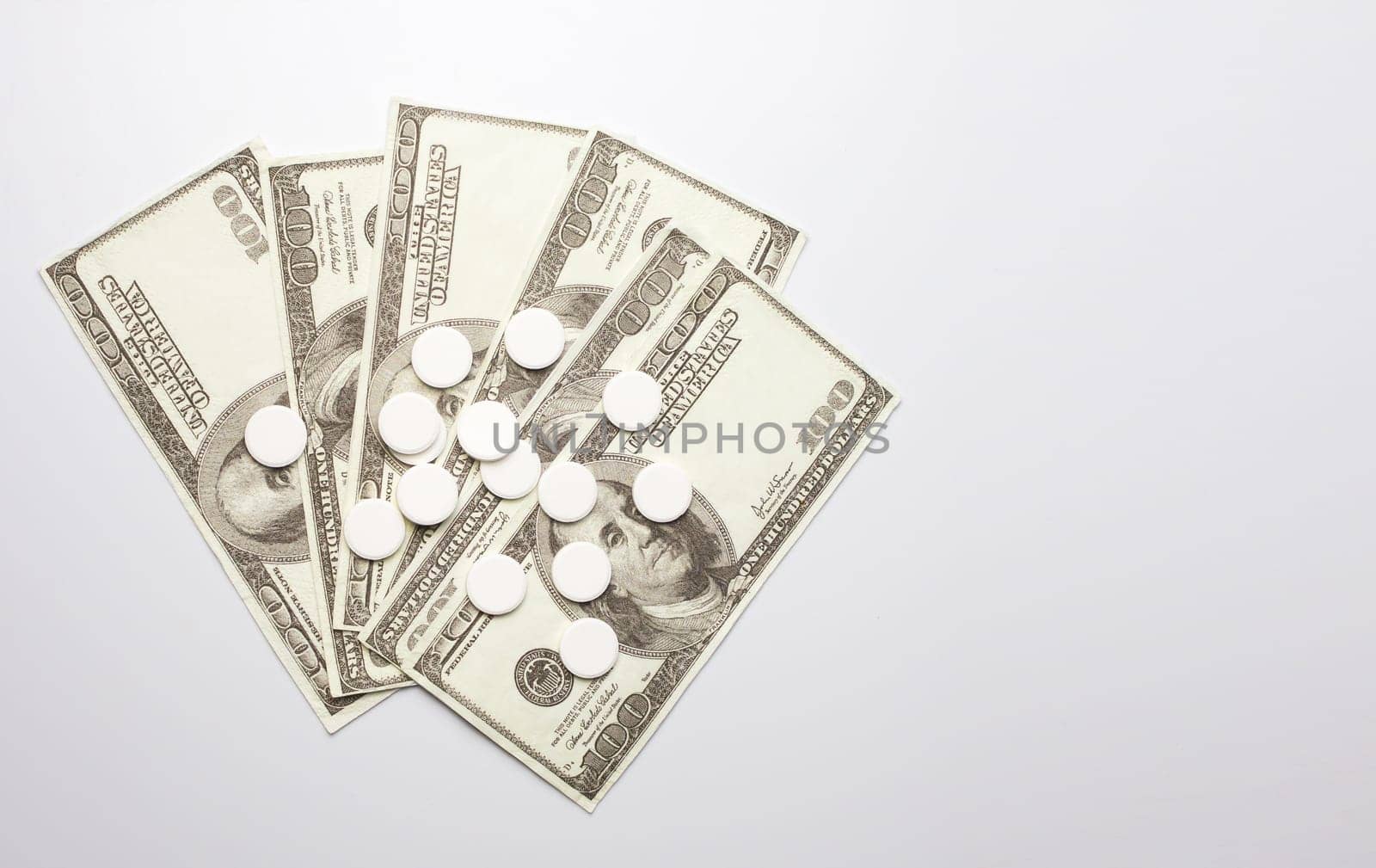 White pills and money, health expense concept, health care cost, medical business