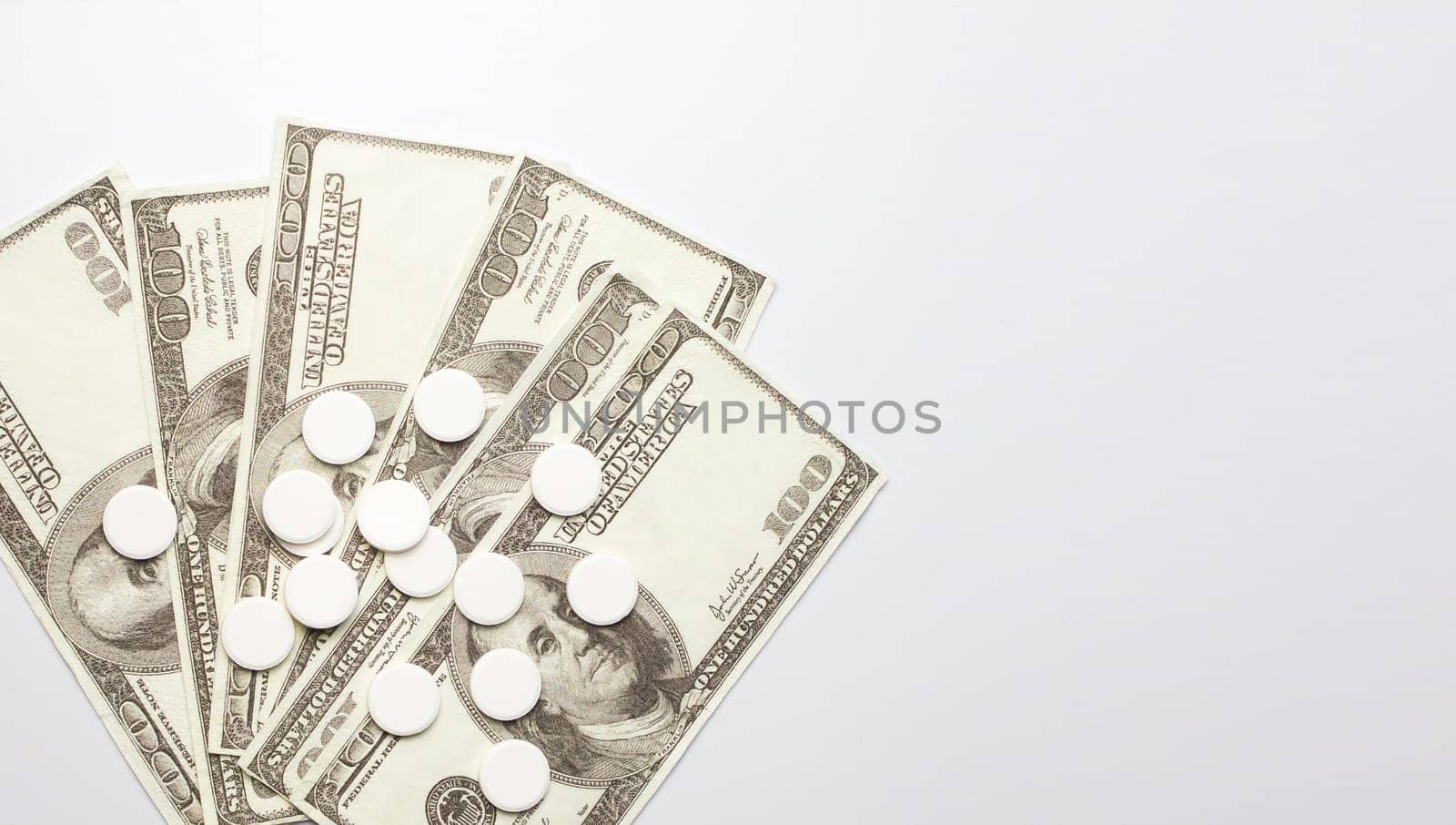 White pills and money, health expense concept, health care cost, medical business