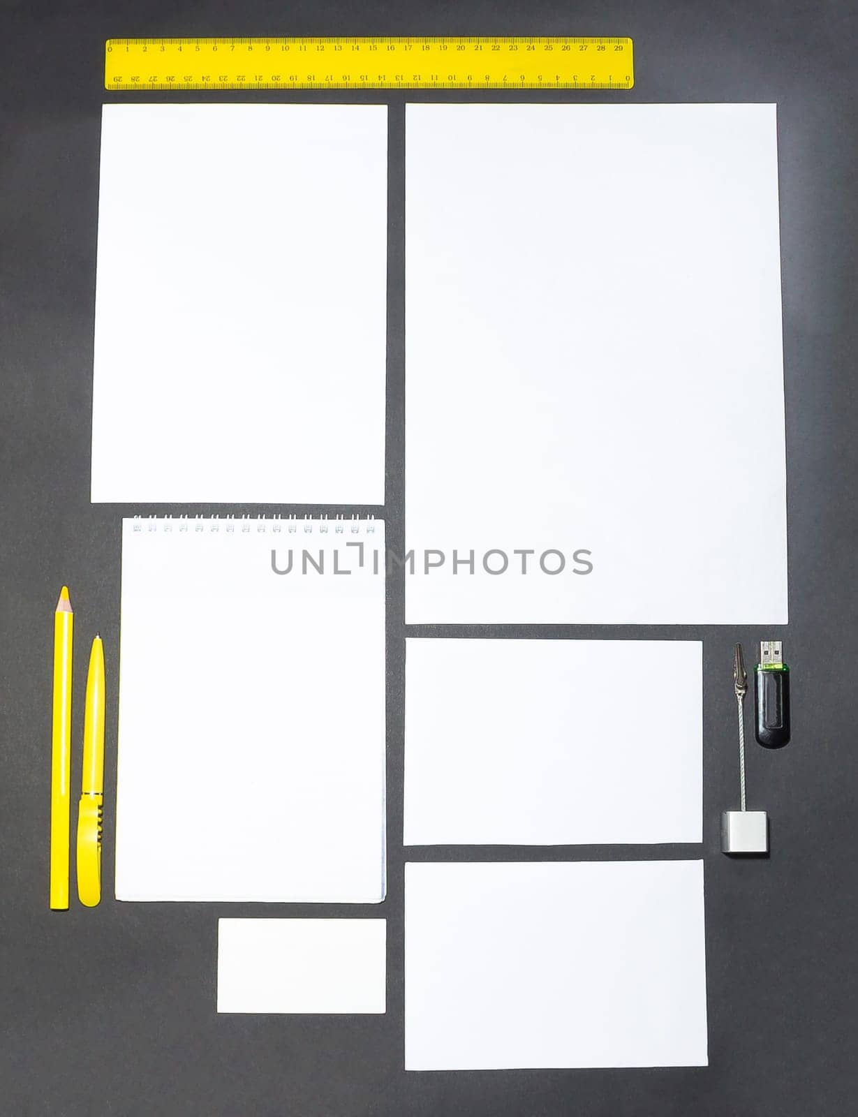 Mock-up business template with cards, papers, pen on gray background.
