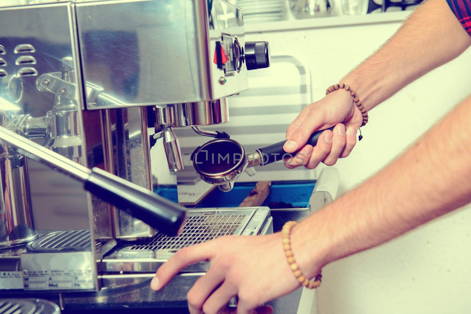 man using espresso metallic machine with portafilter