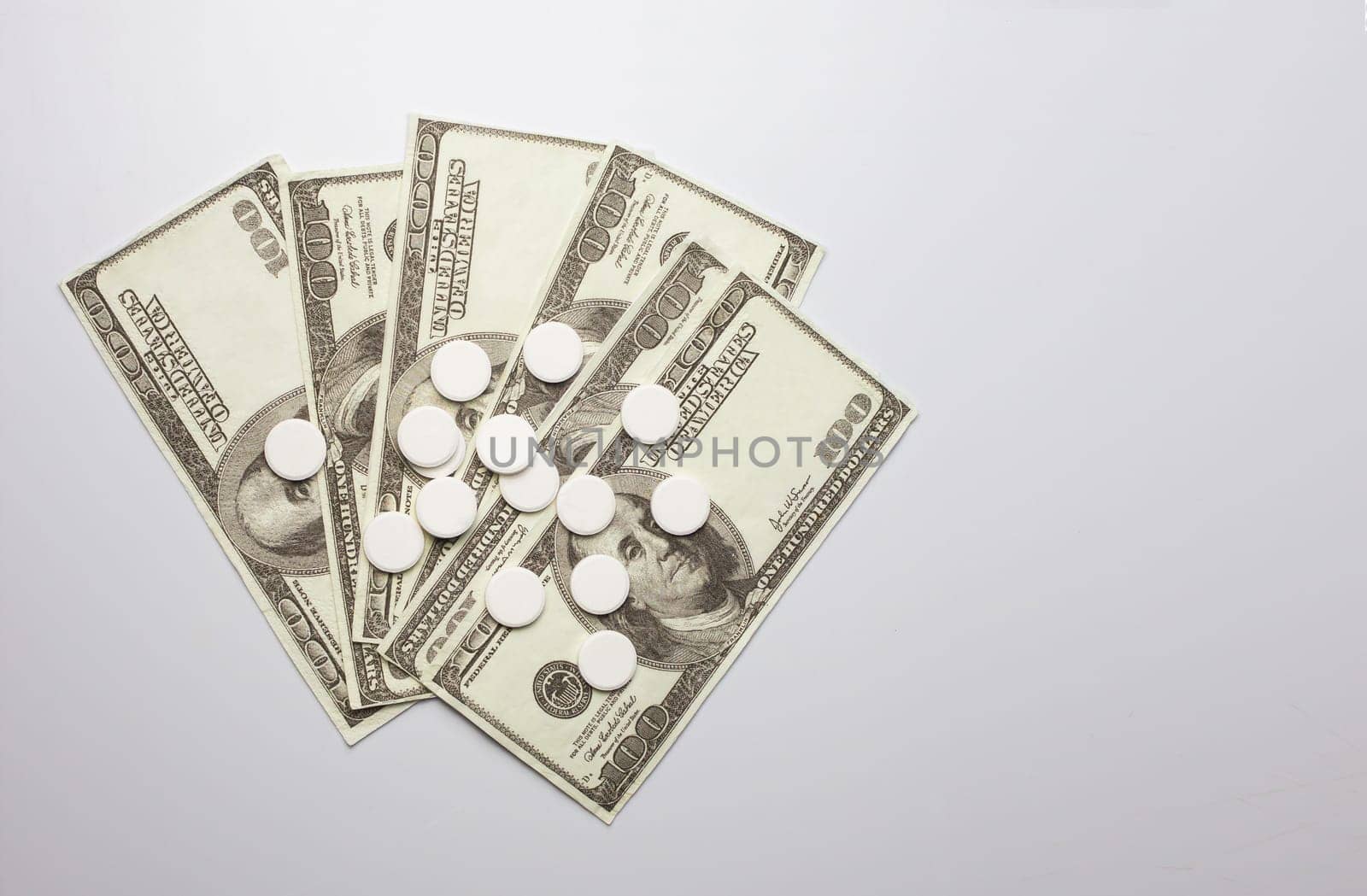 White pills and money, health expense concept, health care cost, medical business