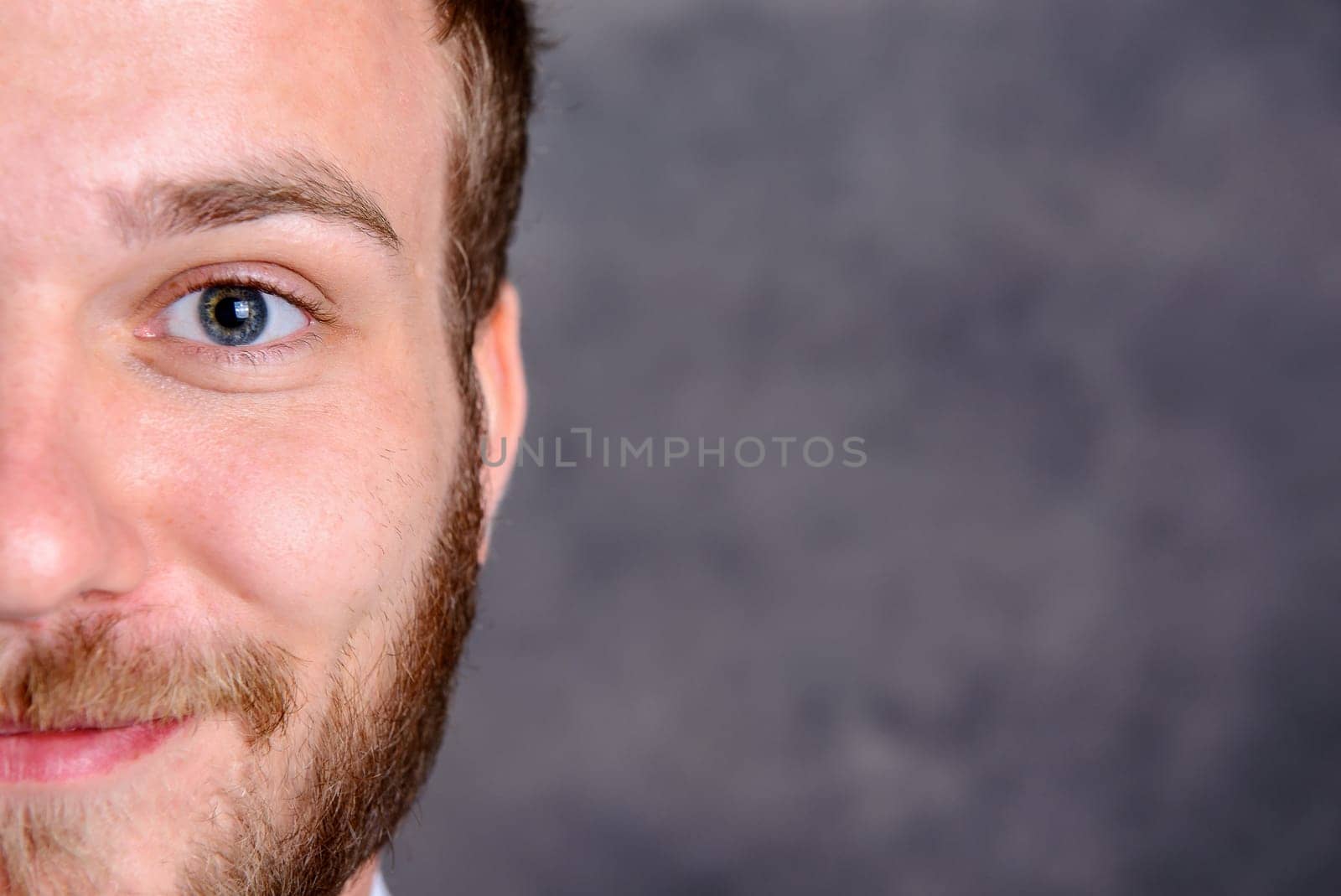 close up - portrait of a young friendly, bearded man