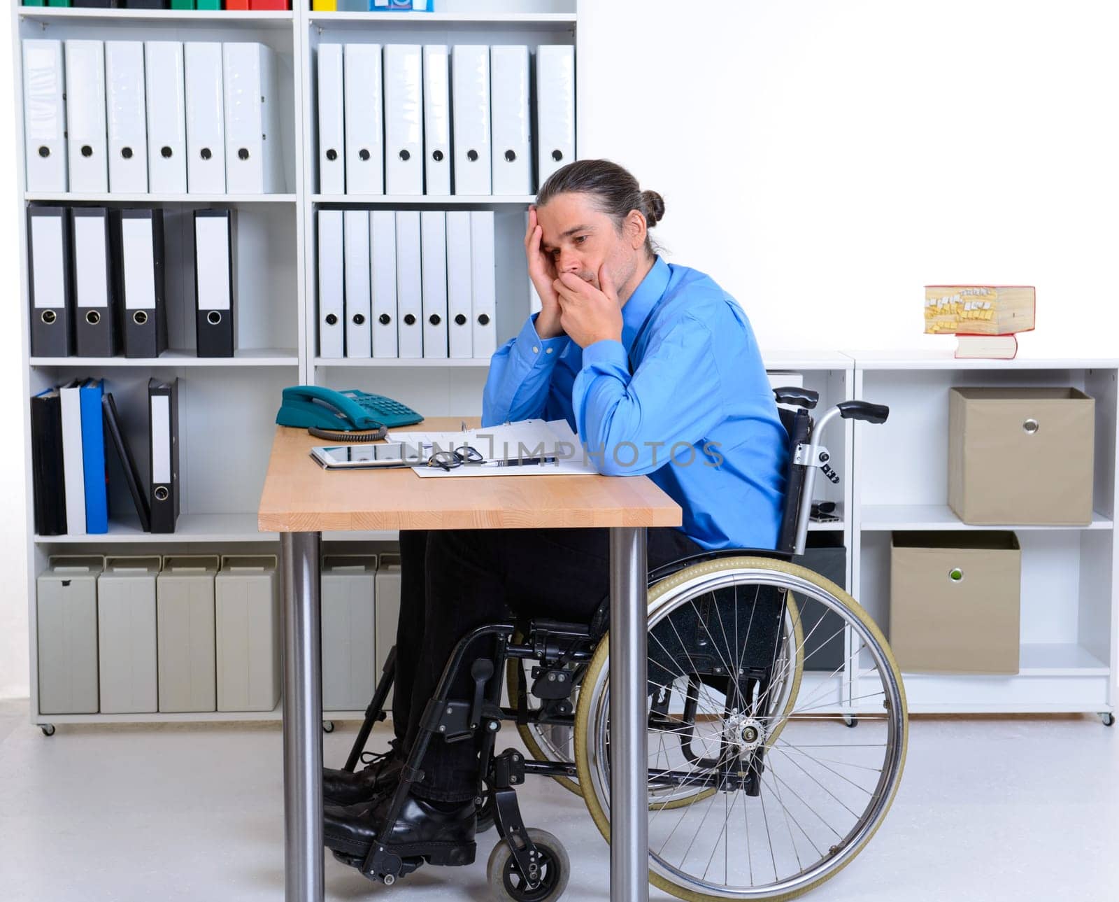 disabled business man in wheelchair is depressed