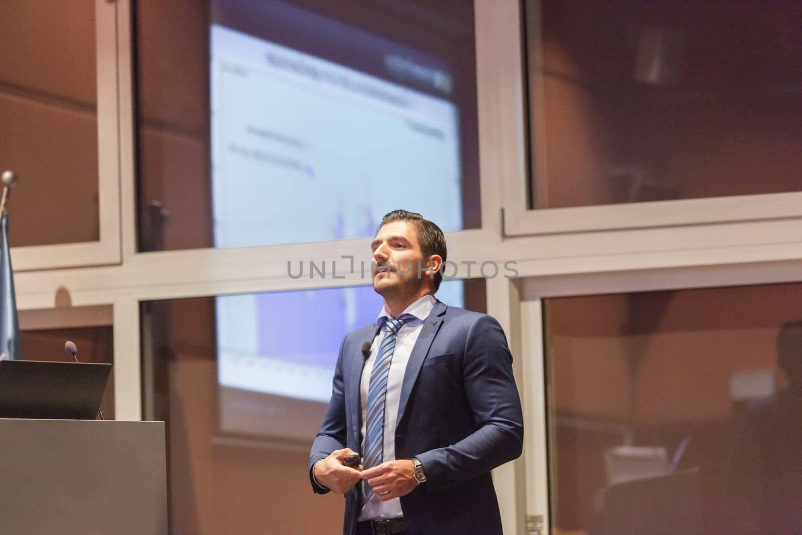 Speaker giving talk on podium at Business Conference. Entrepreneurship club. Horizontal composition.