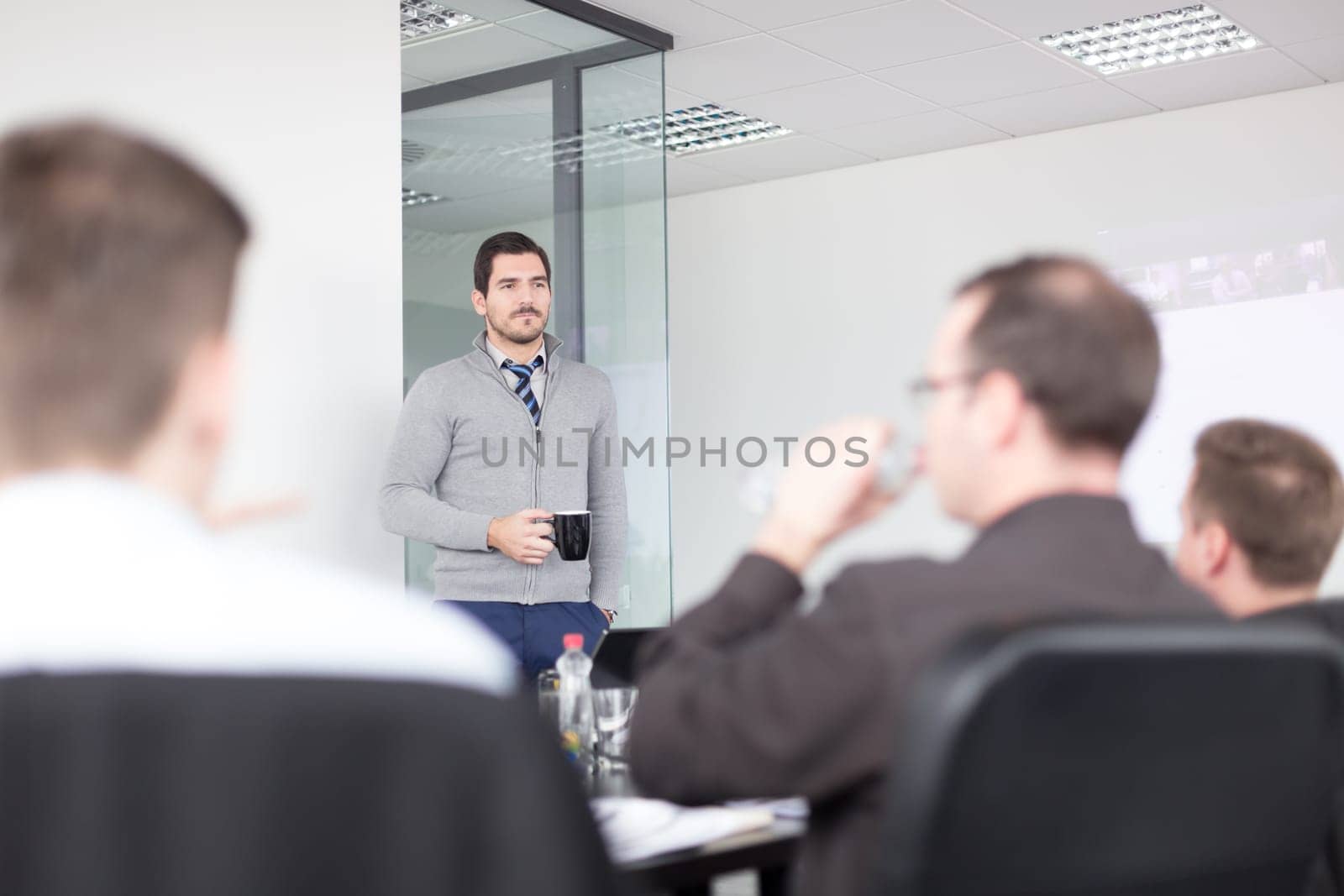 Relaxed cheerful team leader and business owner leading informal in-house business meeting. Business and entrepreneurship concept.