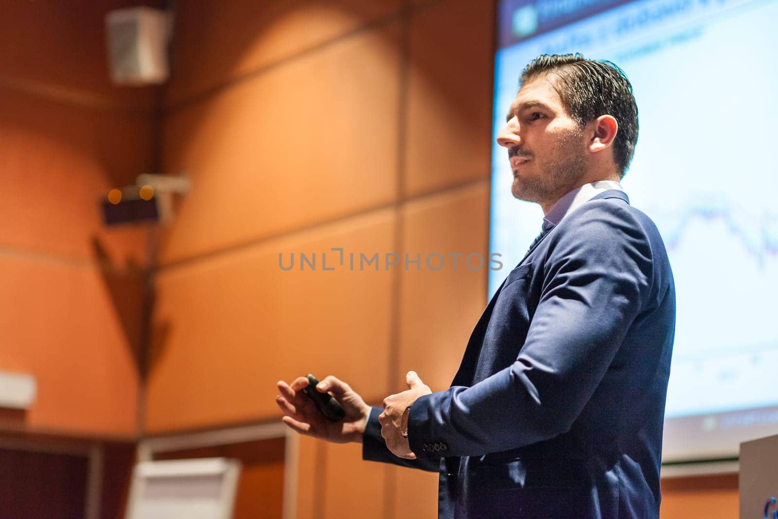 Speaker giving talk on podium at Business Conference. Entrepreneurship club. Horizontal composition.