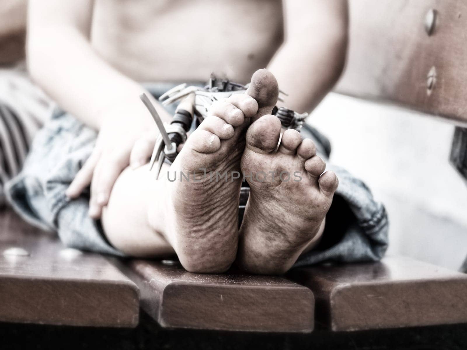 a closeup of dirty feet of a little boy