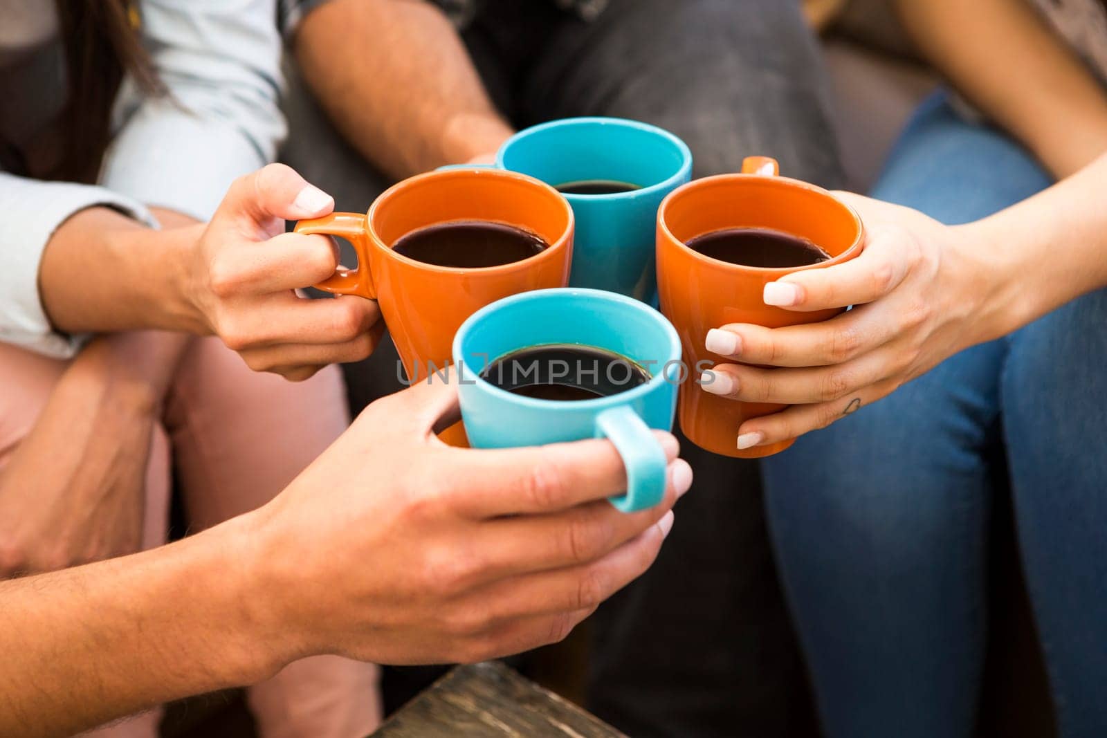 Group of friends making a toast with coffee