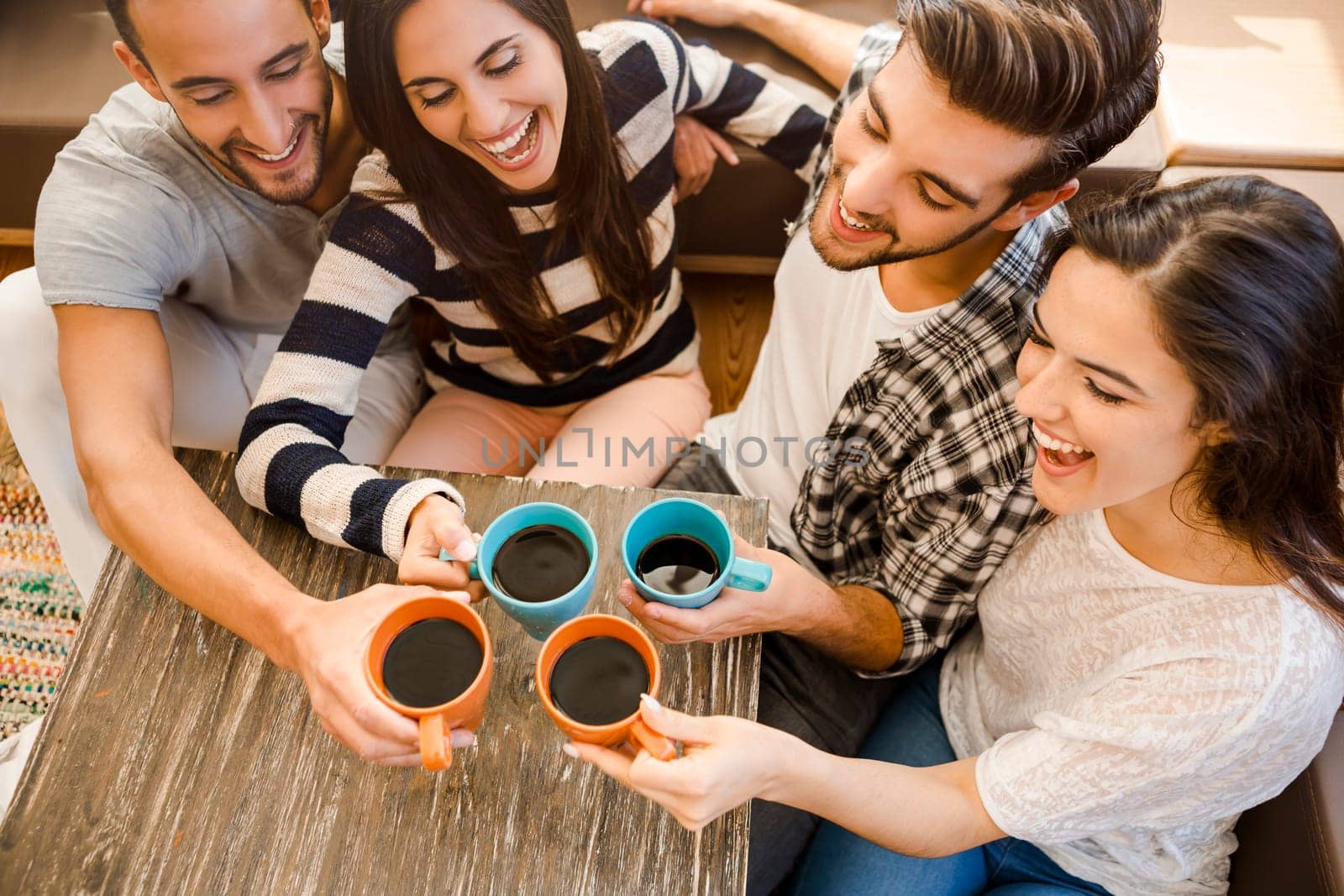 Group of friends making a toast with coffee