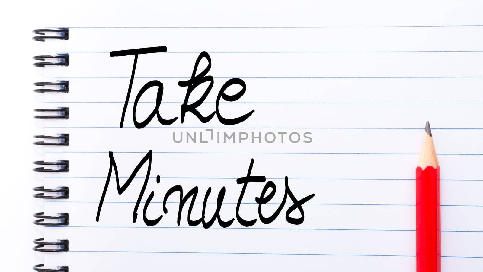 Take Minutes written on notebook page with red pencil on the right