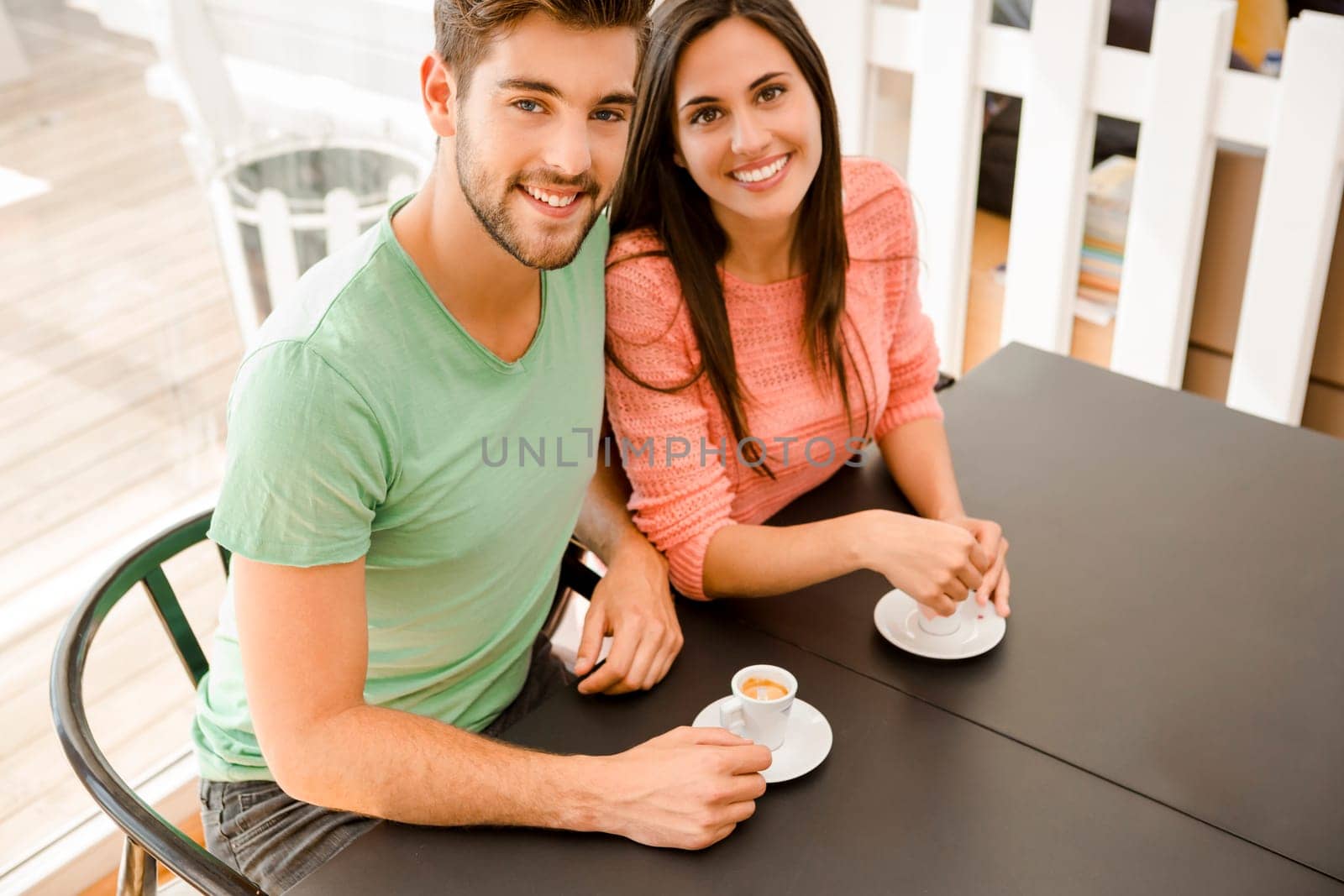 Youg couple at the local coffee shop drinking a coffee