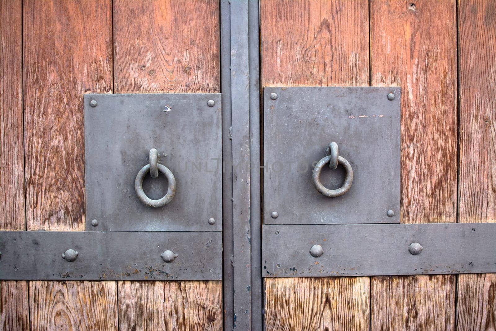 Wooden door with metal handlers