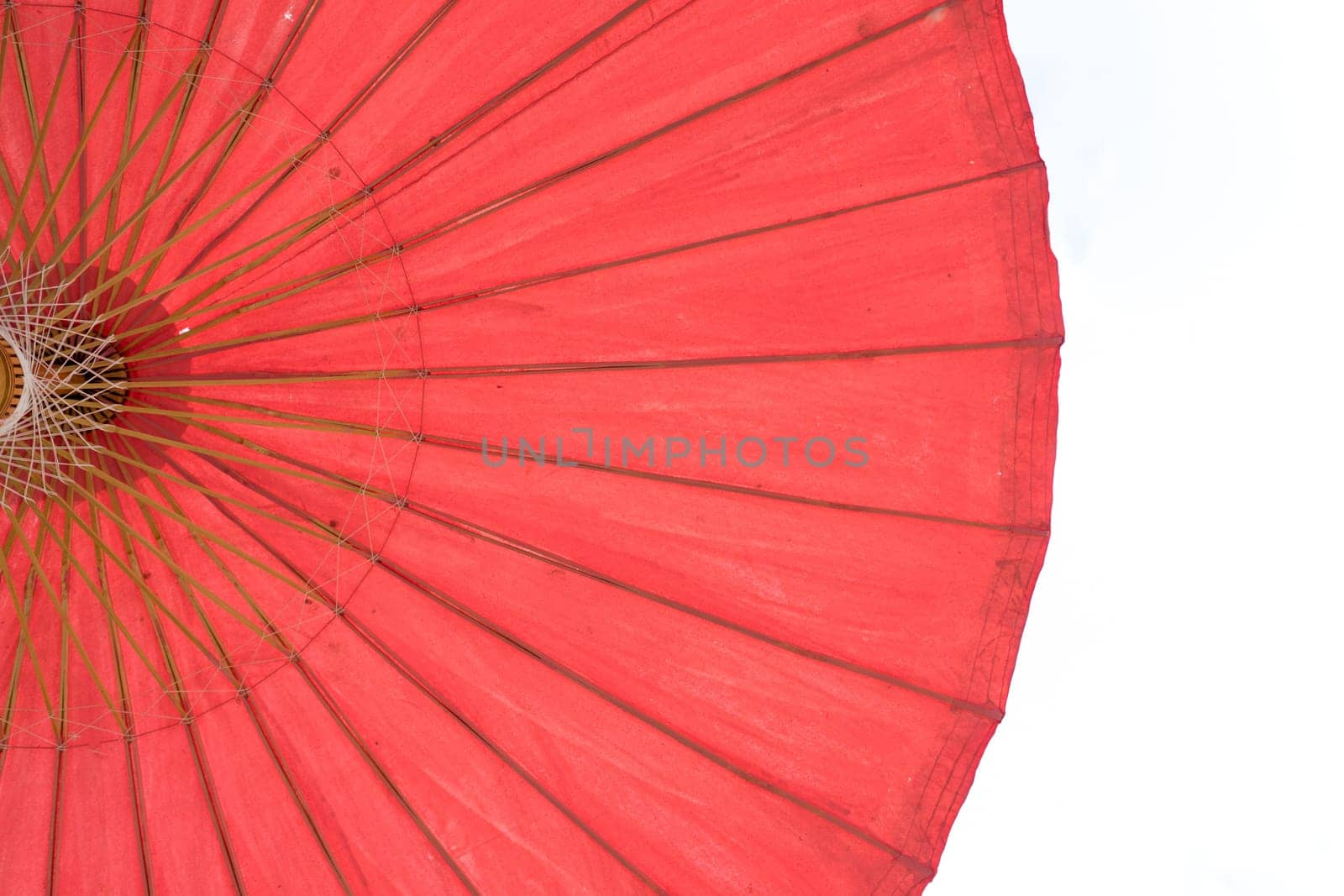 Structure under an old red umbrella white background