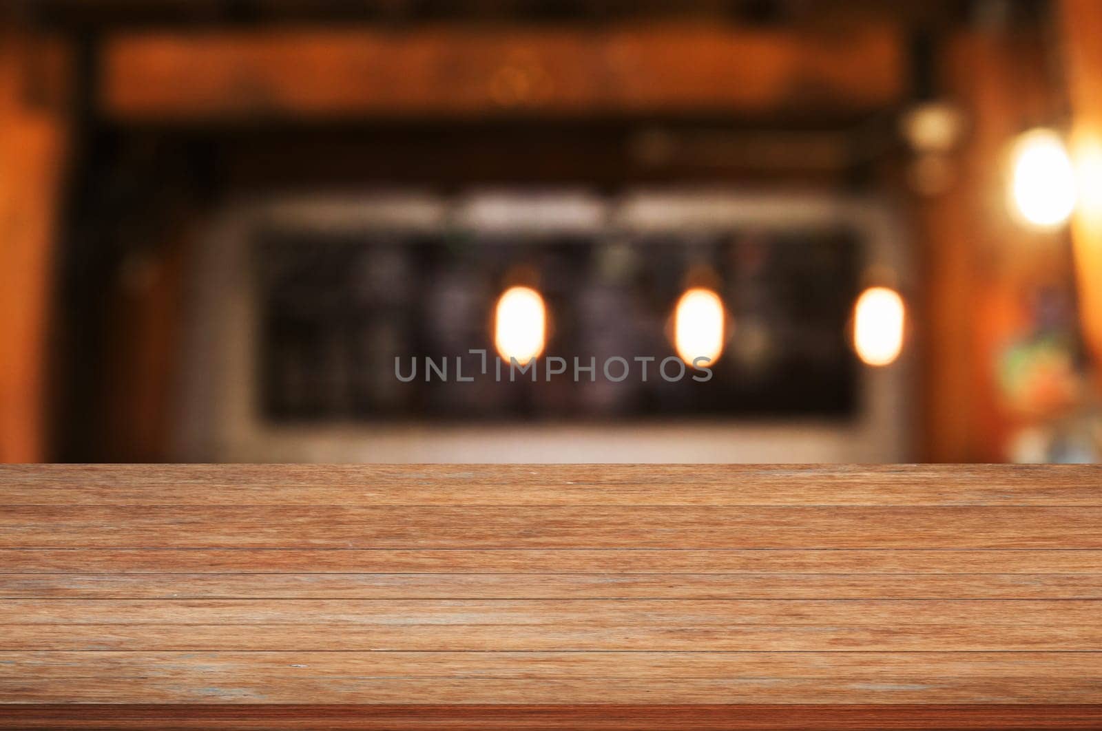 Top of wooden table top with coffee shop blurred abstract background