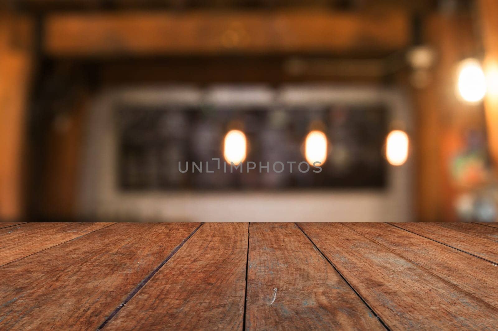 Wooden table top with coffee shop blurred abstract background