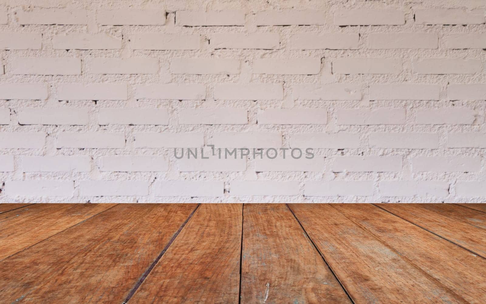 Wooden table top with brick wall decorated in coffee shop