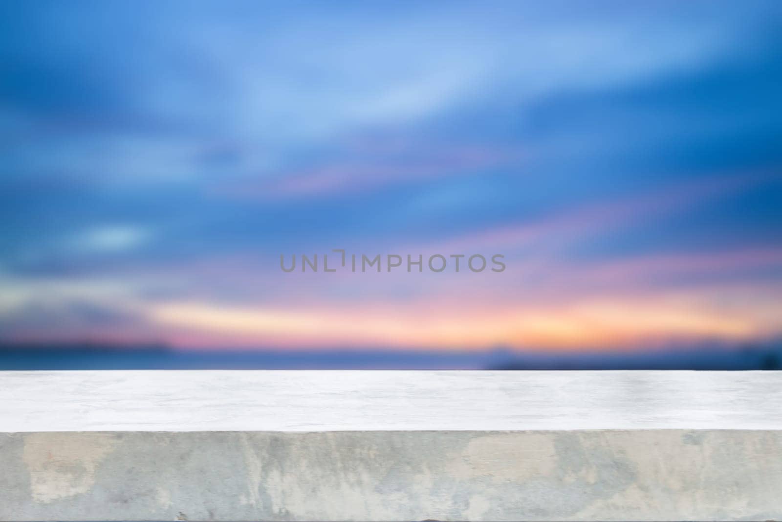 Concrete table top with sunset abstract blur background, stock photo