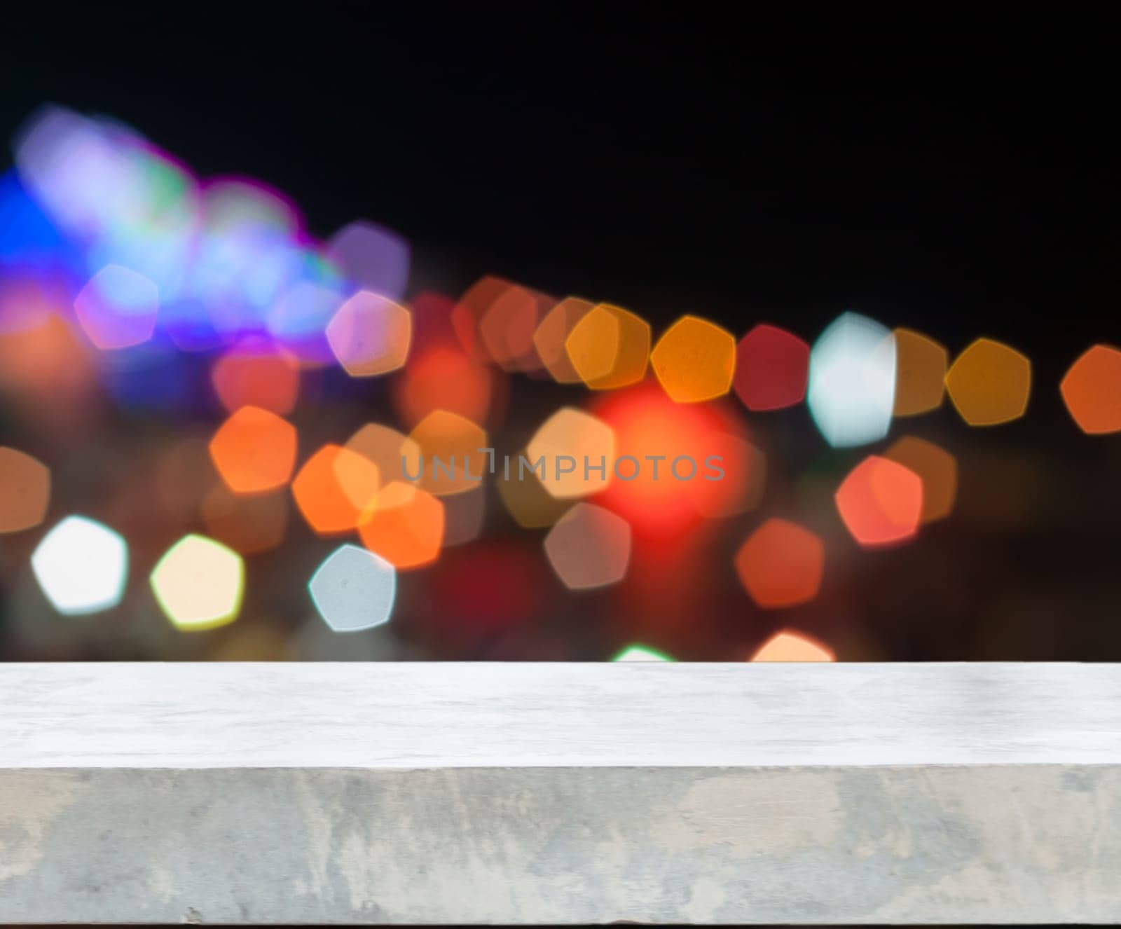 Concrete tabletop with abstract blurred lights, stock photo