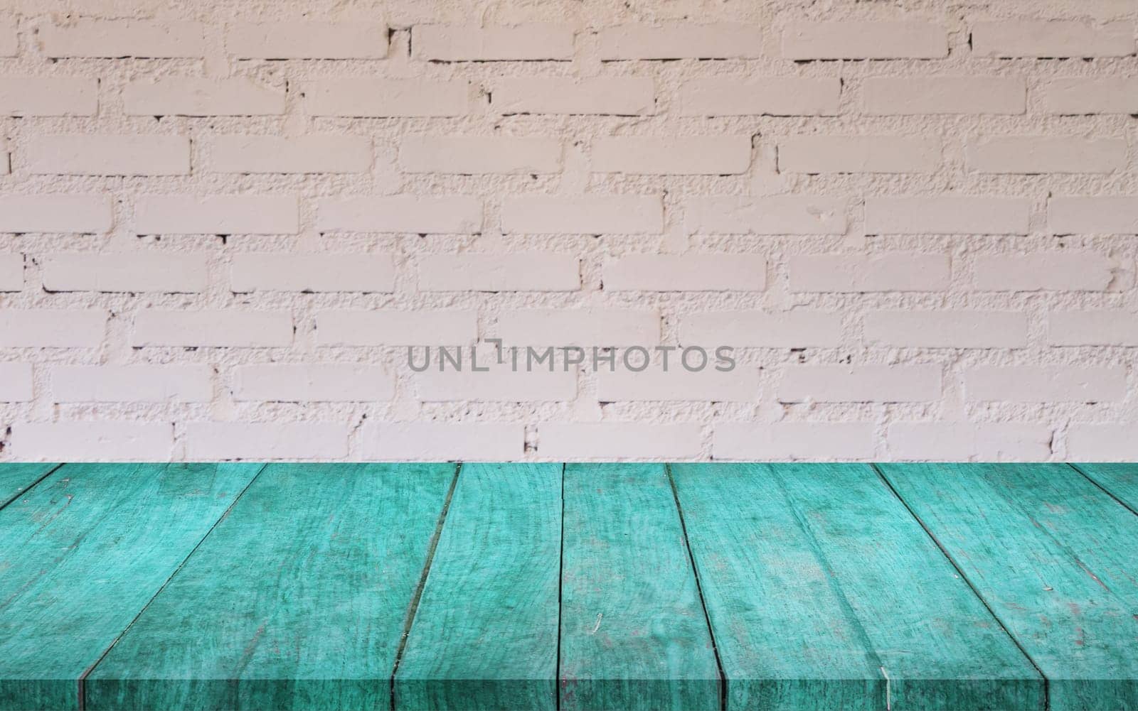 Blue wooden table top with white brick wall decorated in coffee shop