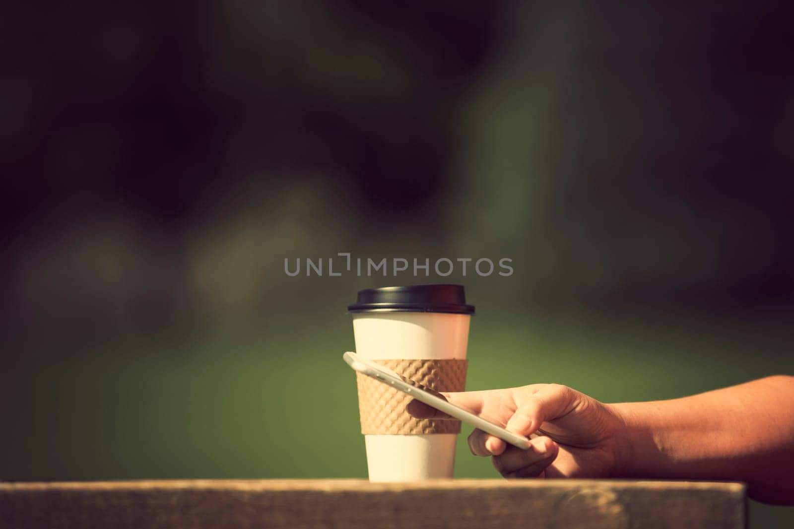 Woman holding smart phone outdoors
