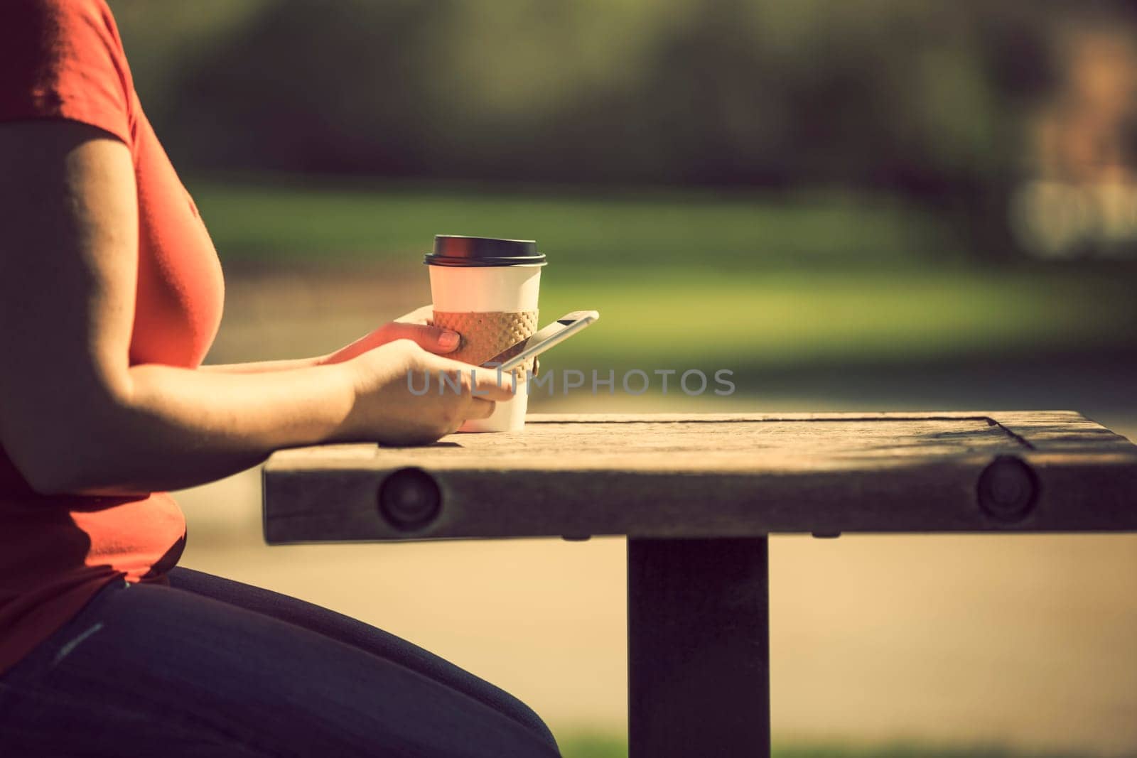 Woman holding smart phone outdoors