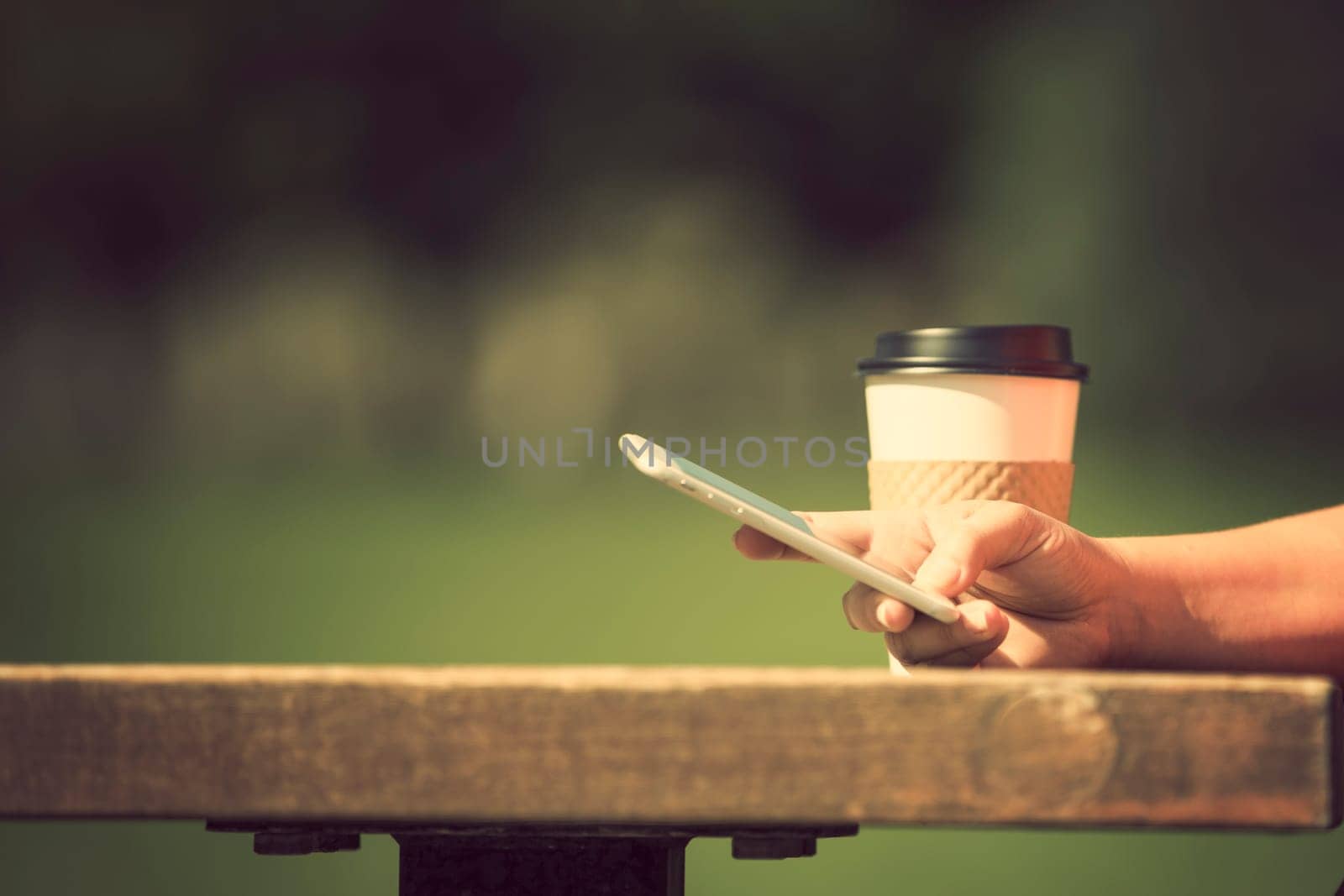 Woman holding smart phone outdoors