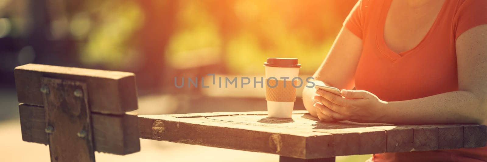 Woman holding smart phone outdoors