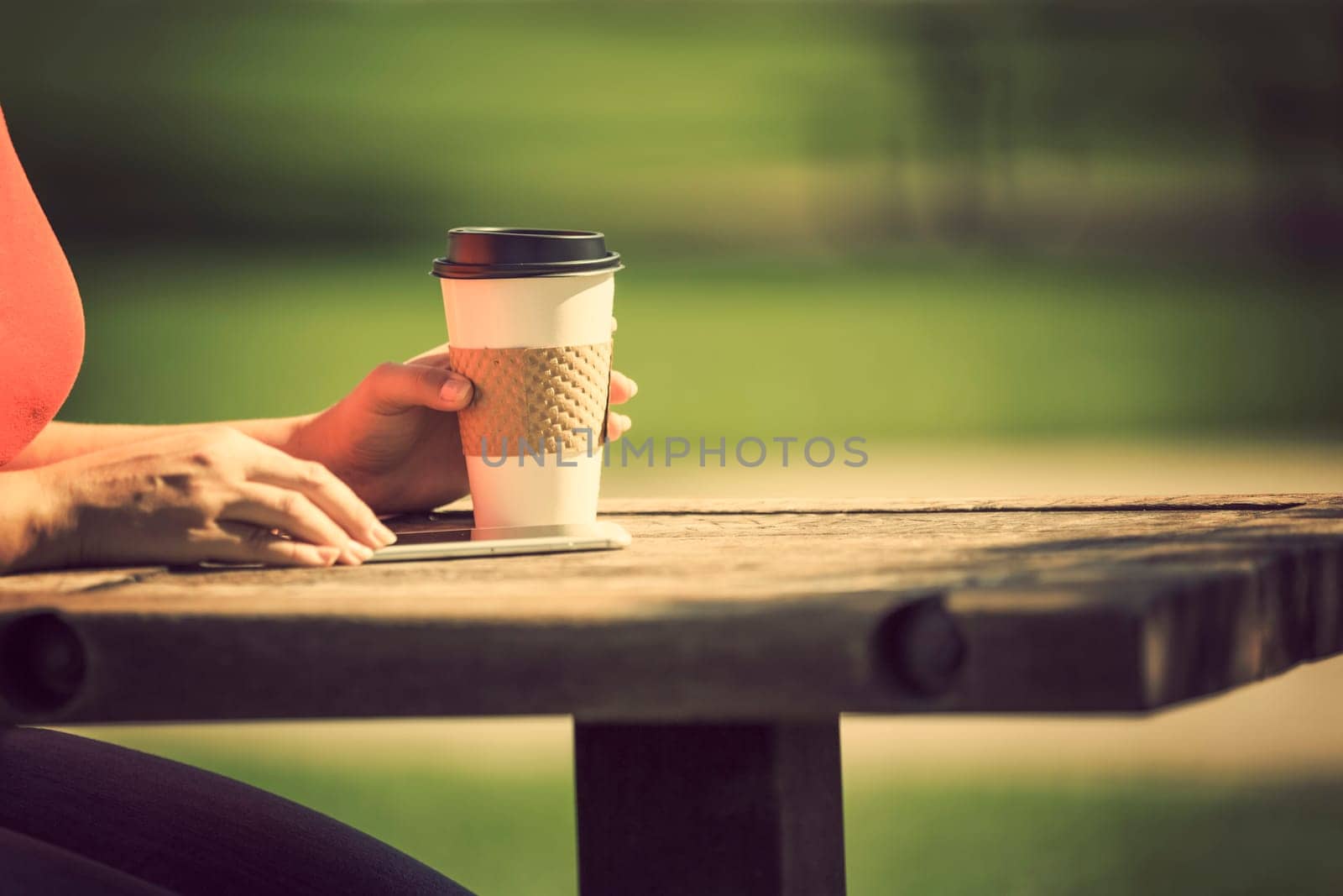 Woman holding smart phone outdoors