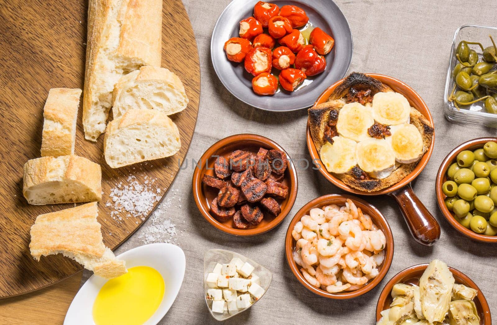 Tapas food, served in small bowls cold meat, goat cheese. A meal for sharing