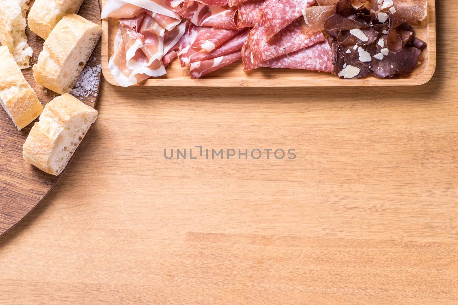 Tapas food, served in small bowls cold meat, goat cheese. A meal for sharing