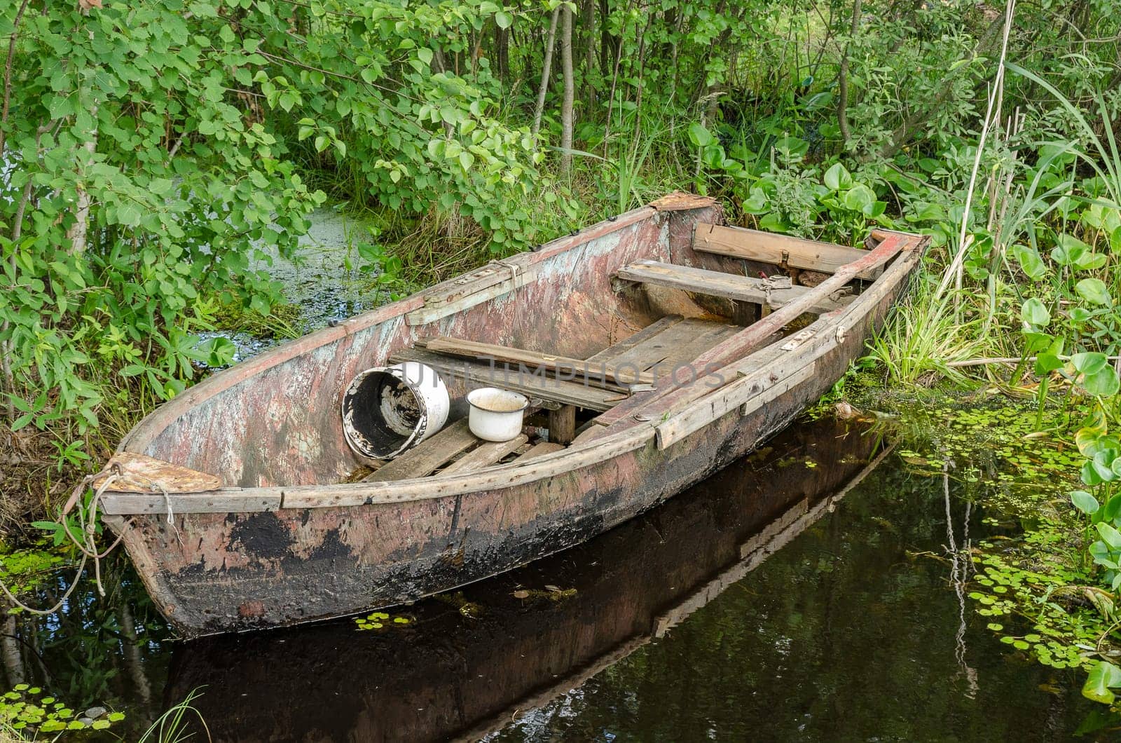 Wooden boat on the dock by the lake