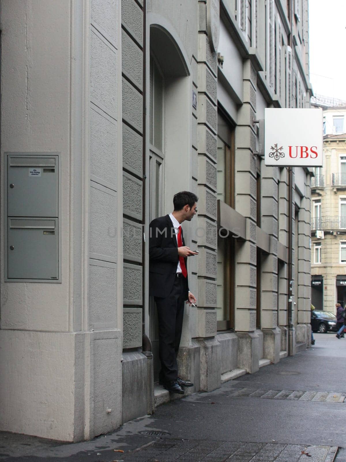 Zurich, Switzerland - November 27, 2011. Office clerk went out to smoke