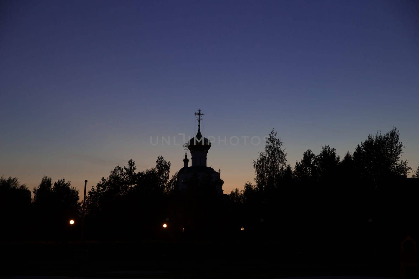 Evening view of the white-stone church near park