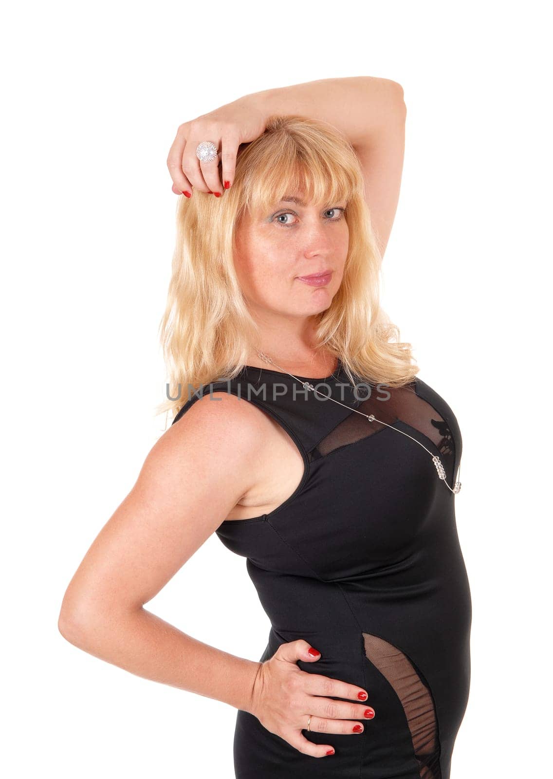 A portrait image of a lovely blond woman standing in a black .evening dress, isolated for white background..