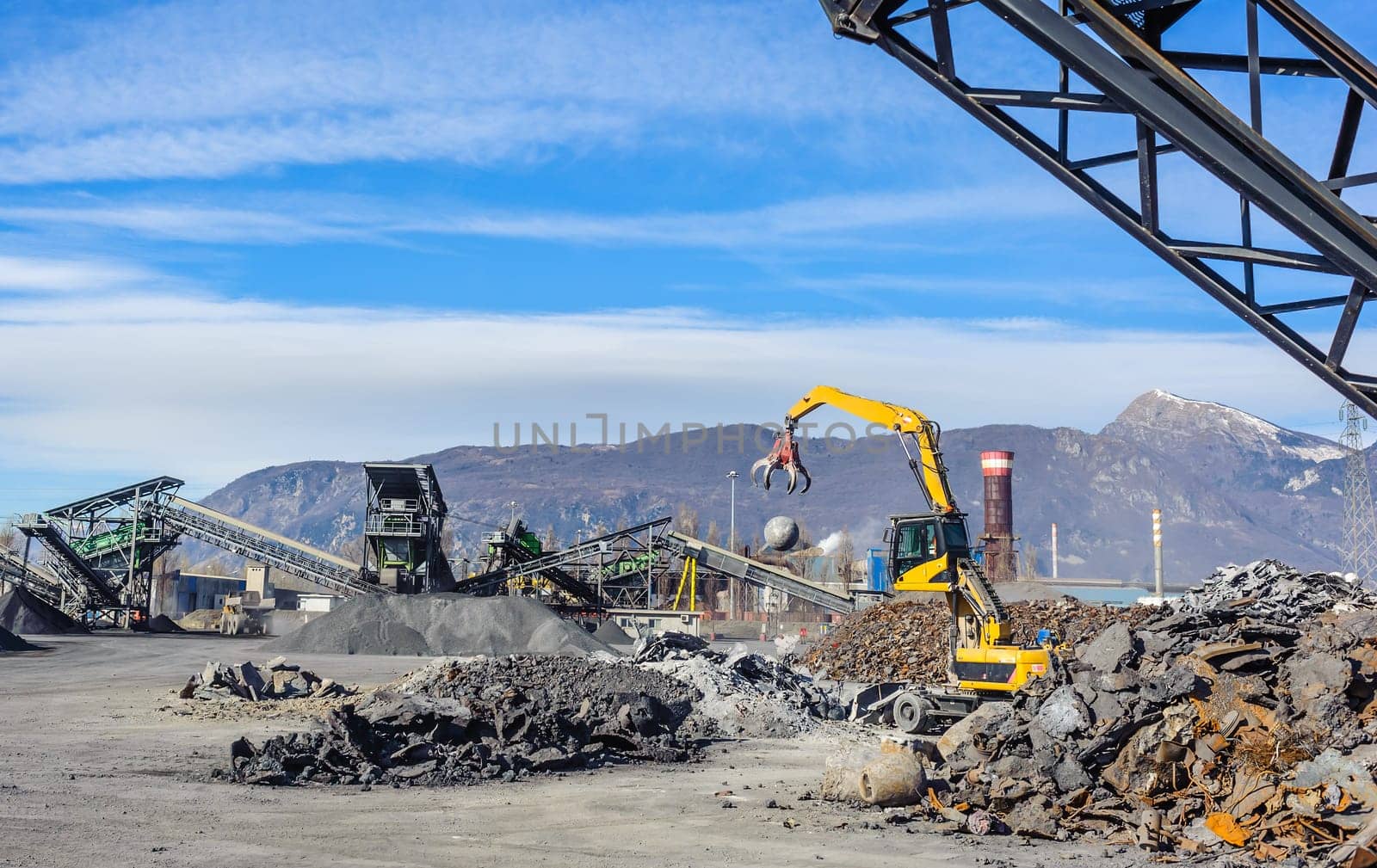 Treatment plant wastes of foundry, with excavator and crane.