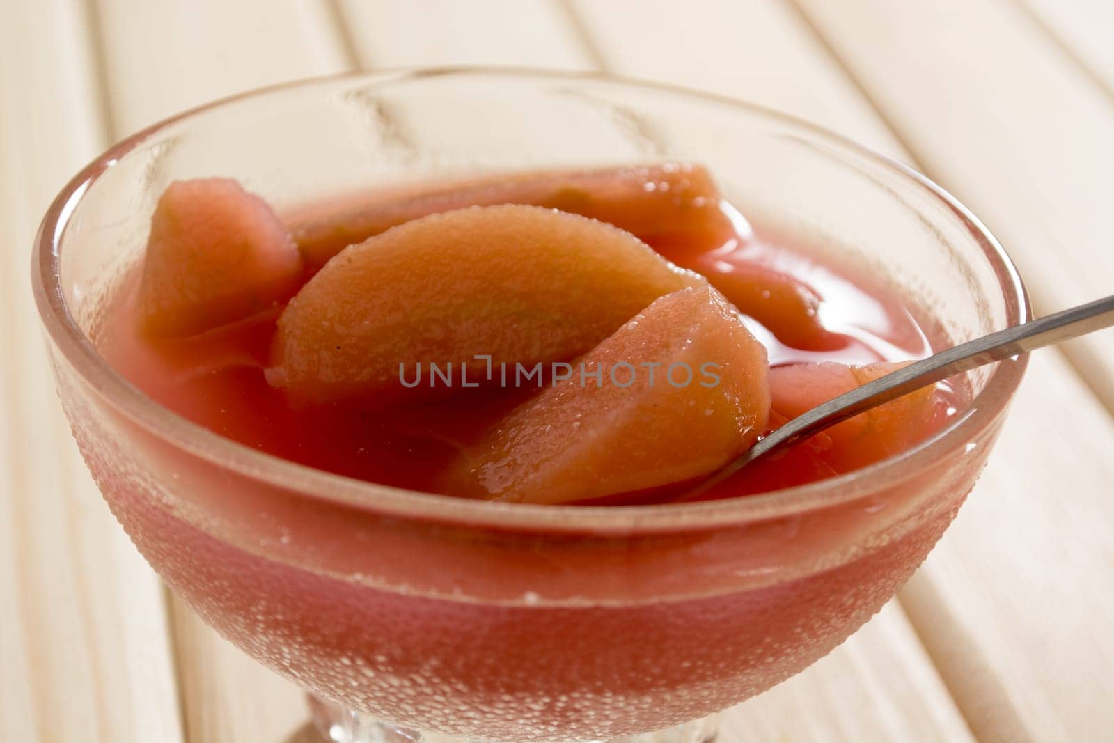 Compote of dried apple in the bowl on a wooden table