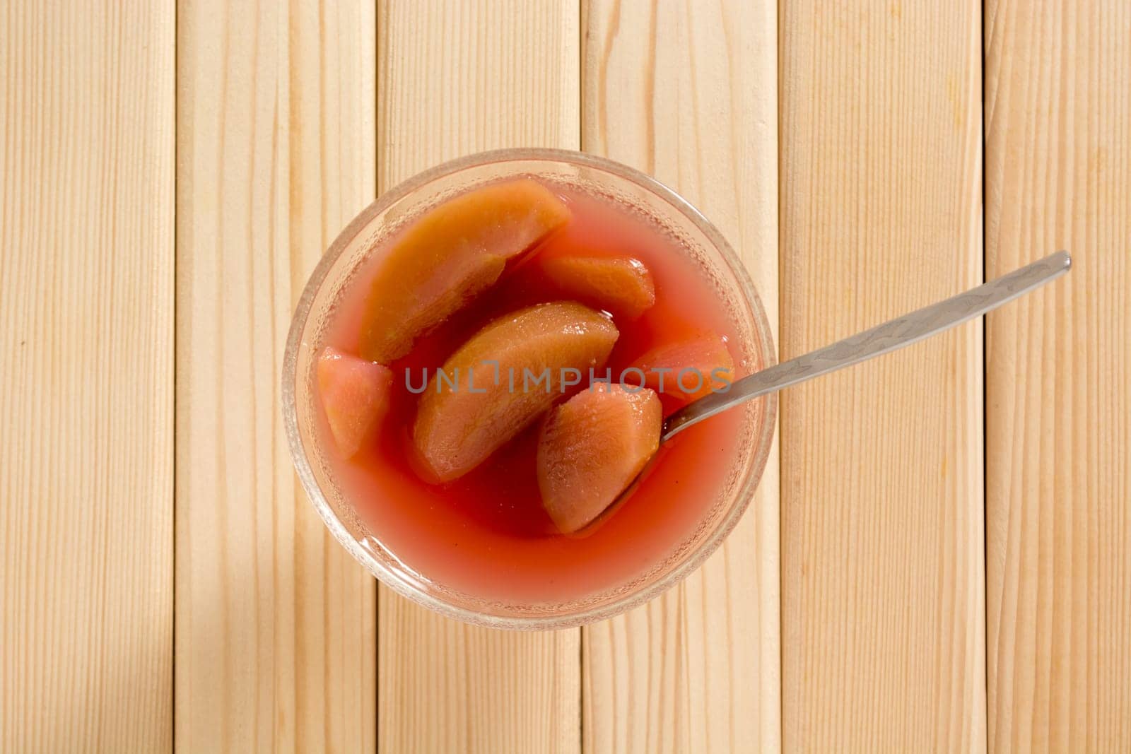 Compote of dried apple in the bowl on a wooden table