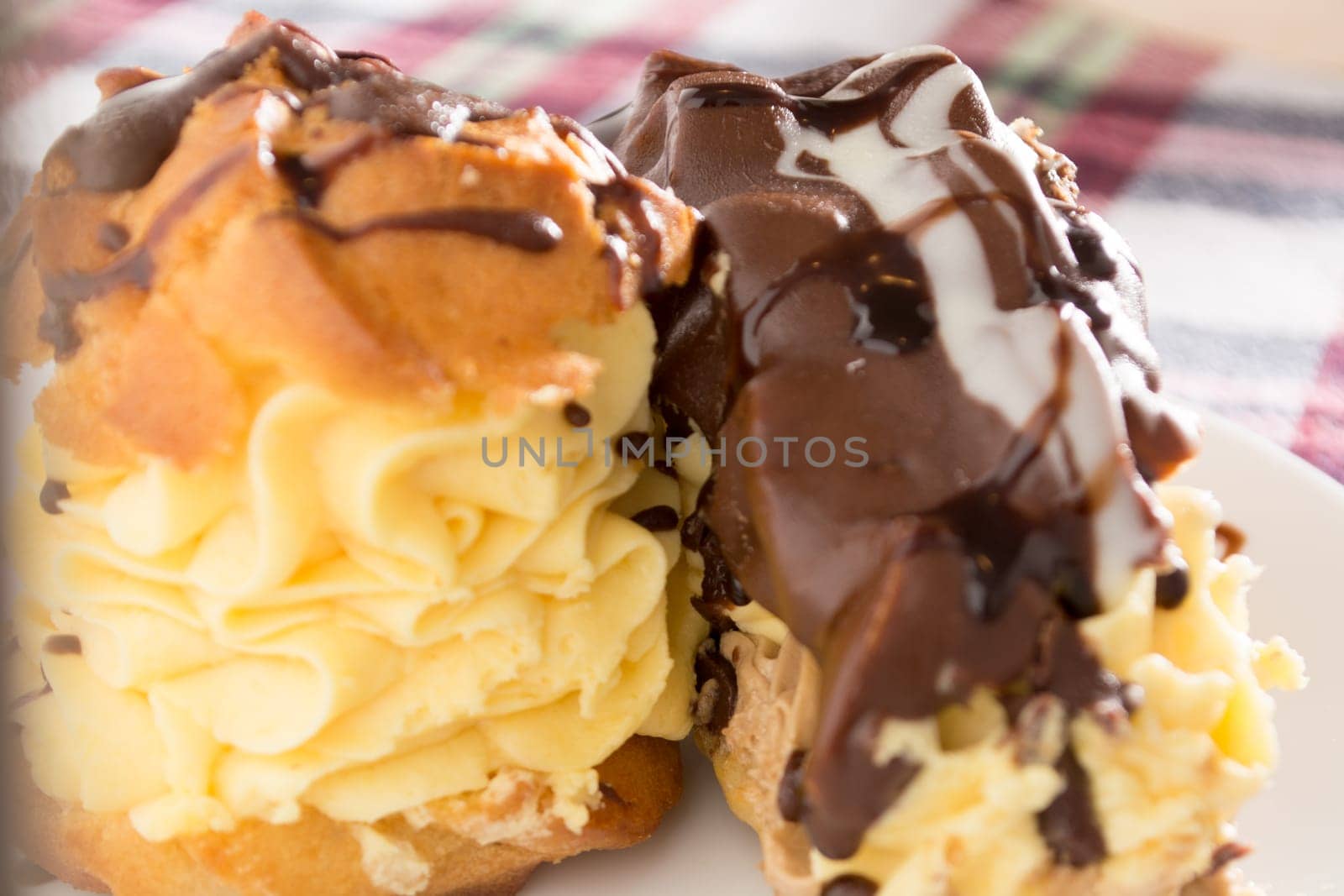 Cream Pie. Two layers of puff pastry filled with whipped cream decorated with melted chocolate on a white plate
