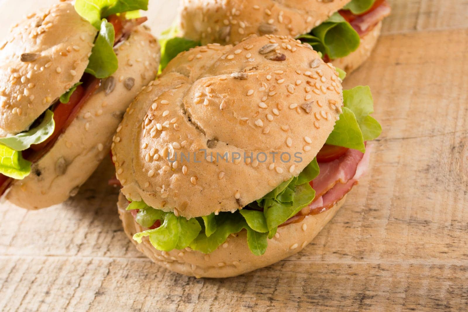Sandwiches with fresh smoked meat, cheese, lettuce and tomato with homemade ketchup