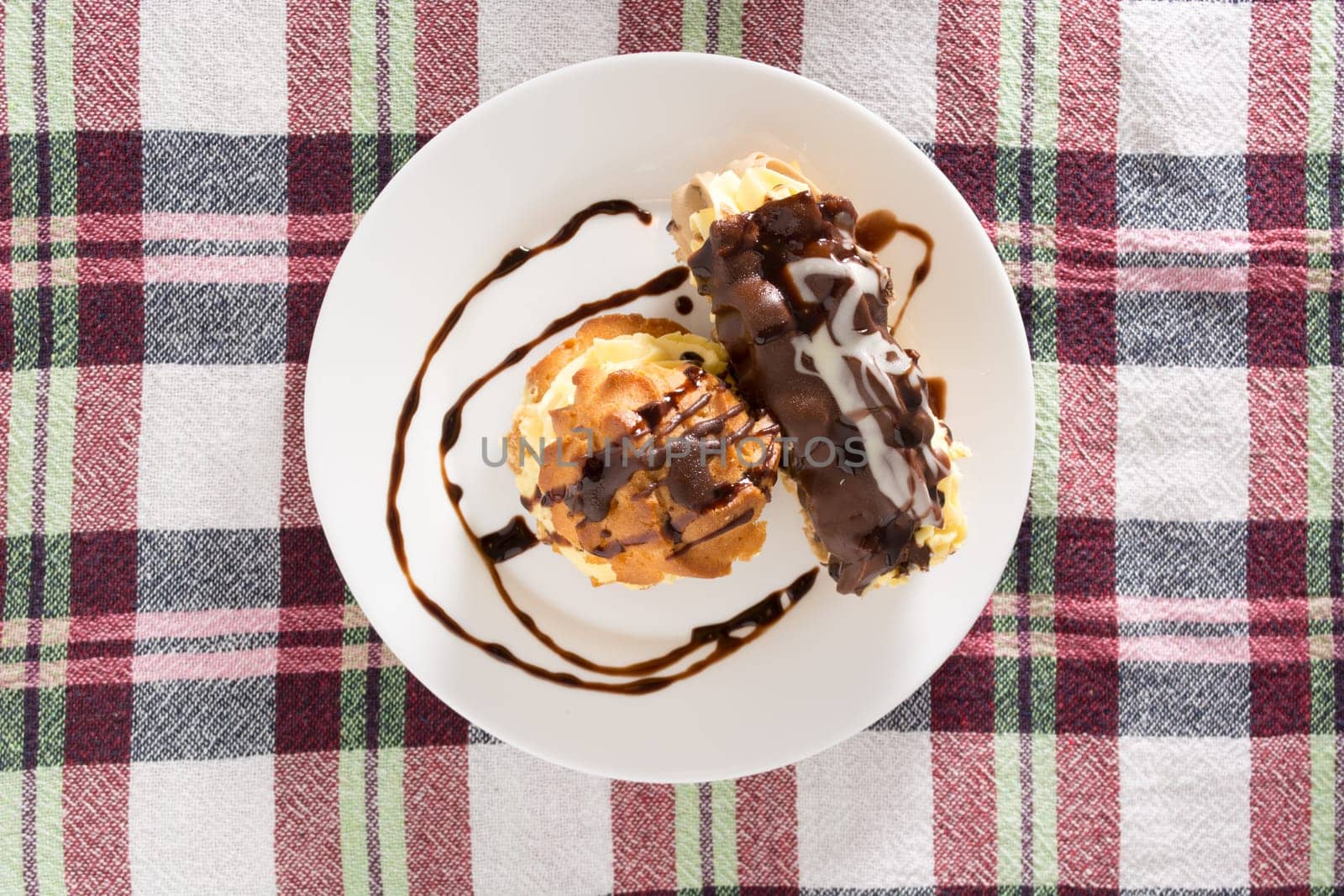 Cream Pie. Two layers of puff pastry filled with whipped cream decorated with melted chocolate on a white plate