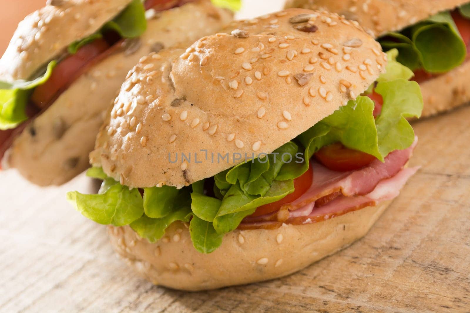 Sandwiches with fresh smoked meat, cheese, lettuce and tomato with homemade ketchup