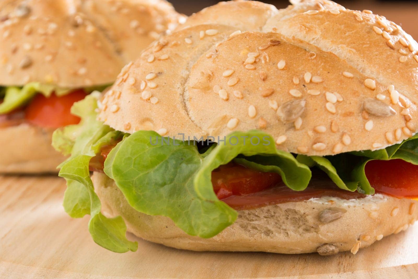 Sandwiches with fresh smoked meat, cheese, lettuce and tomato with homemade ketchup