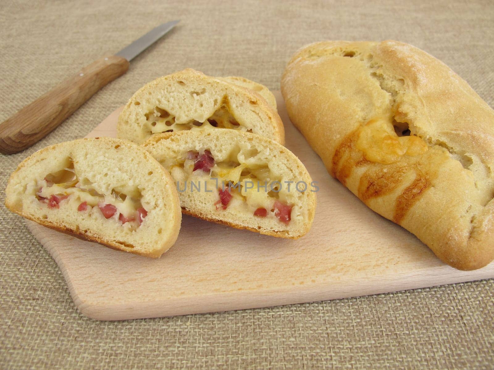 Stuffed pizza bun with cheese and ham