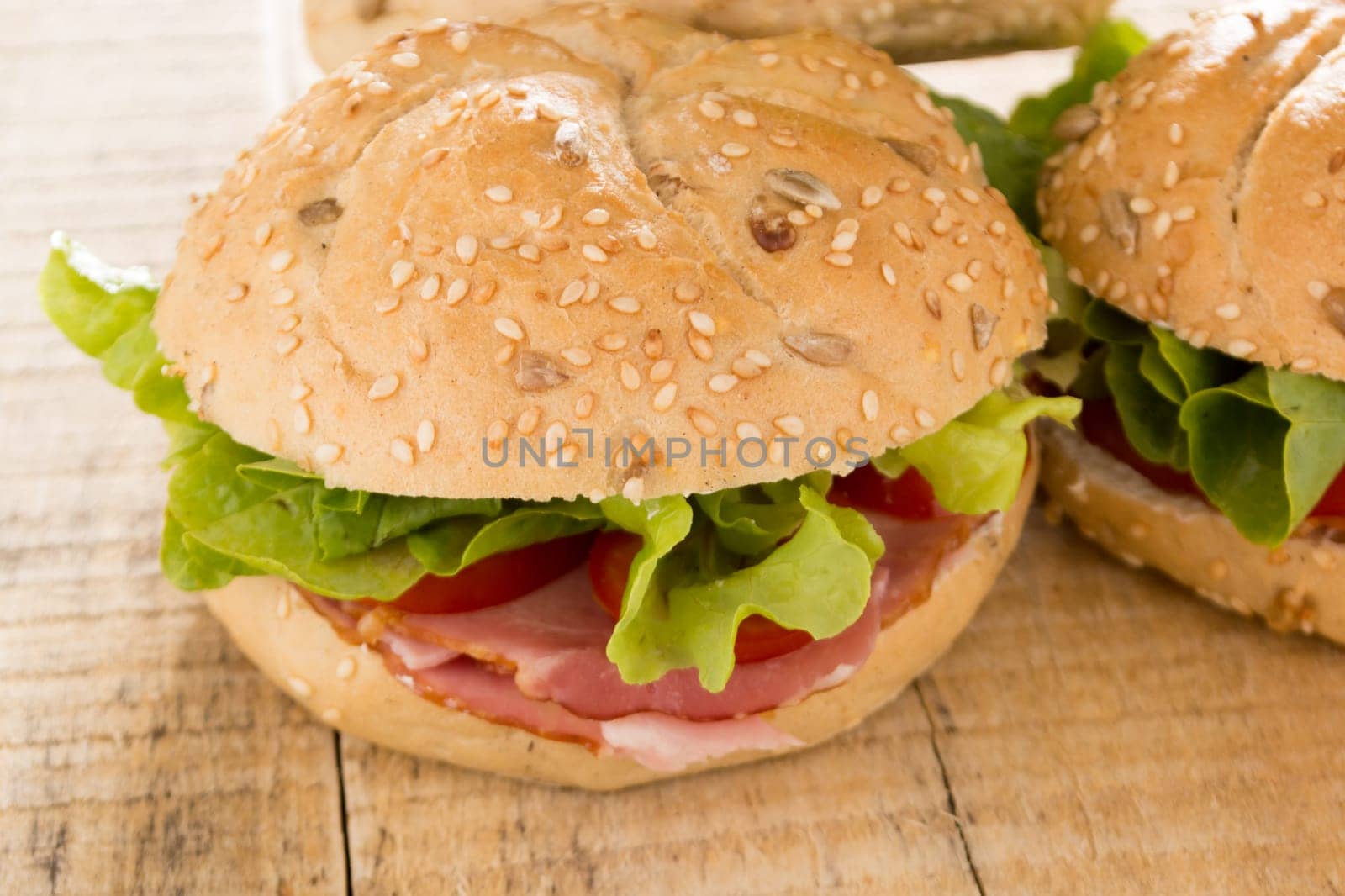 Sandwiches with fresh smoked meat, cheese, lettuce and tomato with homemade ketchup