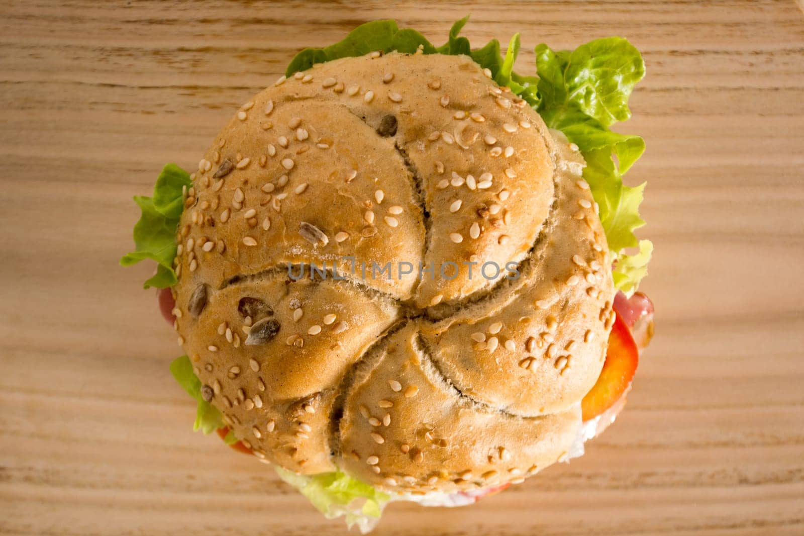 Sandwich with fresh smoked meat, cheese, lettuce and tomato with homemade ketchup