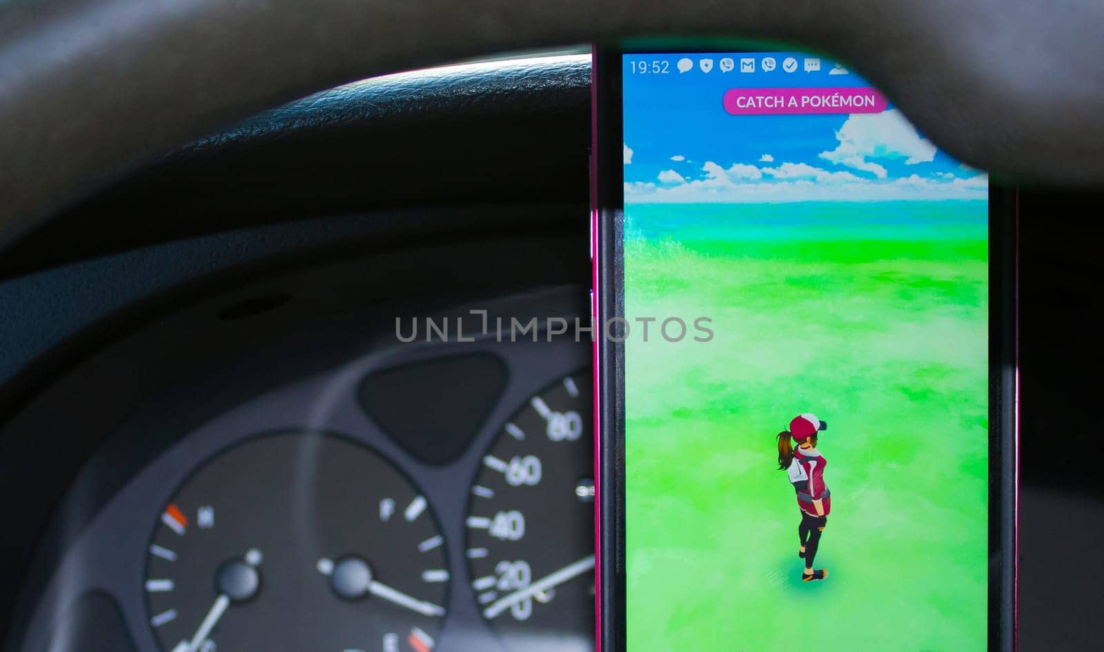 Dnipro, Ukraine - July 23, 2016: An Android user plays Pokemon Go in a car, a free-to-play augmented reality mobile game developed by Niantic for iOS and Android devices.