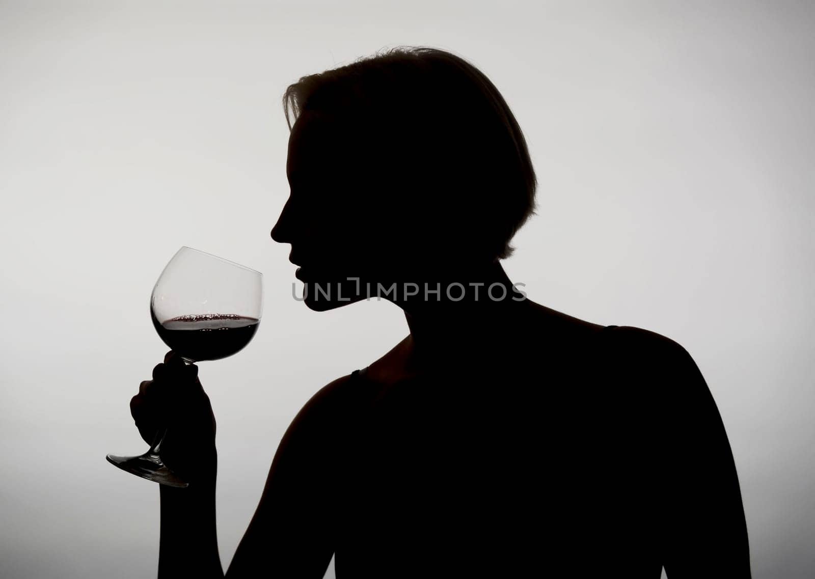Woman drinks red wine